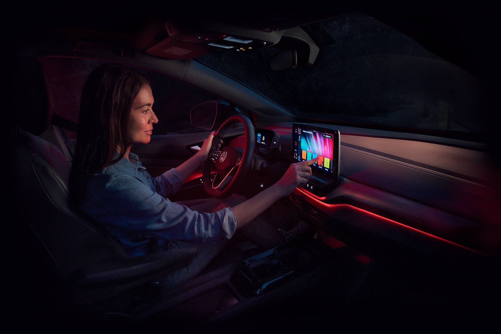 A woman adjusts the ambient lighting inside an ID.4.